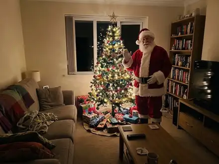 Living room turned into an AI Christmas photo: Santa by the Tree